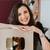 Smiling woman holding YouTube Gold Play Button award for 1 million subscribers achievement