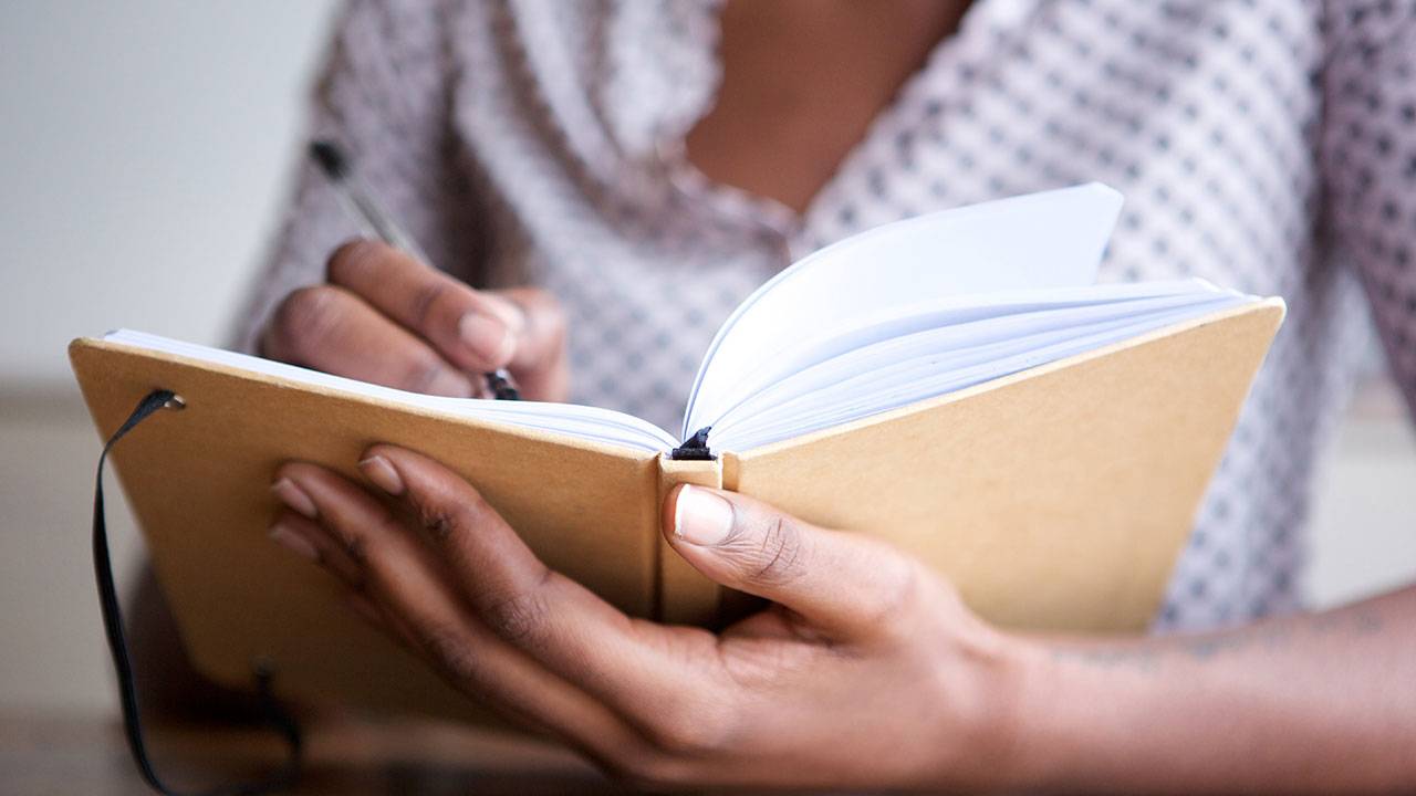 Woman writing in a journal