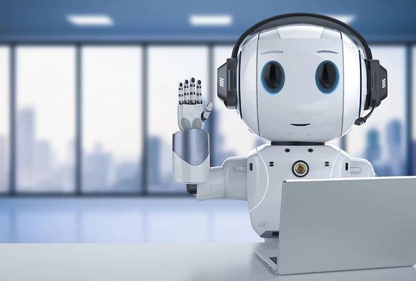 Friendly AI robot with headset waving, sitting at laptop in modern office space