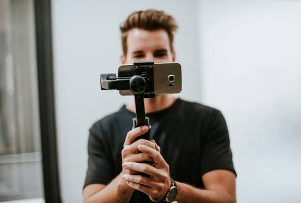 man vlogging using a smartphone