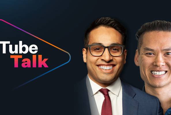 Tube Talk logo with two smiling men in business attire on dark background