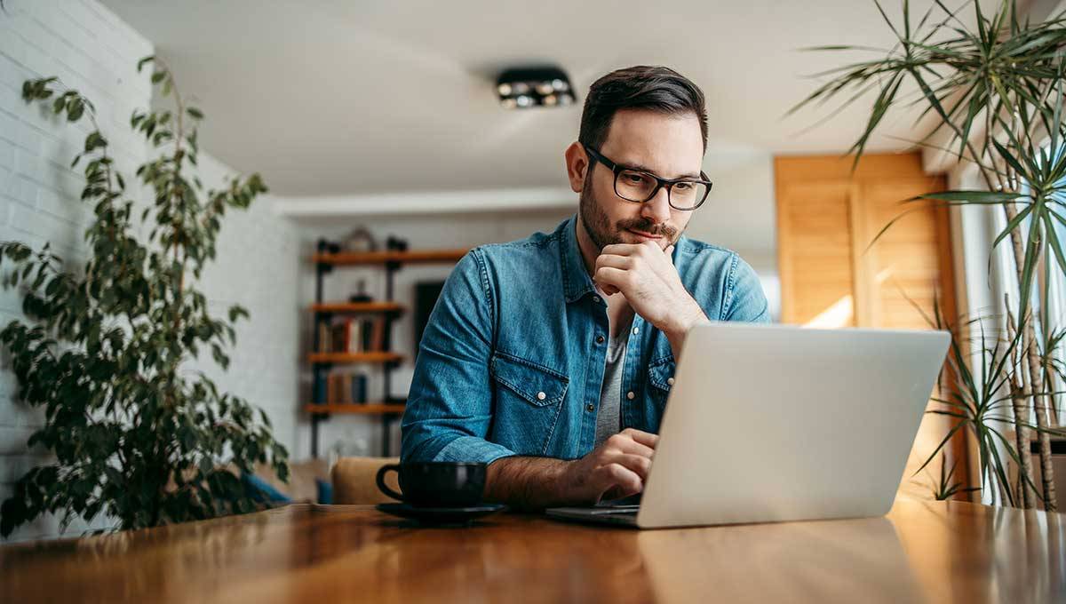 Man thinking while using laptop