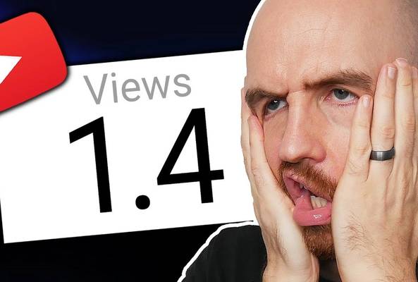 Man shocked by low 1.4k YouTube views on video analytics screen.
