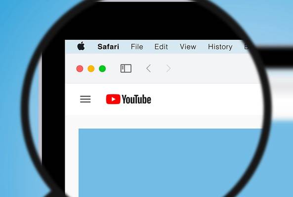 Magnified view of Safari browser window displaying YouTube homepage with navigation menu.