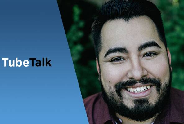 Smiling man with beard next to blue background and TubeTalk logo for video podcast.