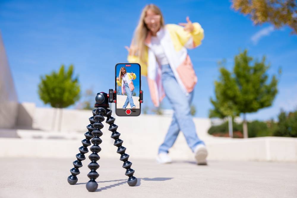 A woman filming a challenge video on her phone