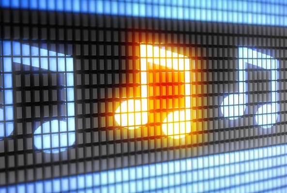Digital display of glowing musical notes with one note highlighted in orange light