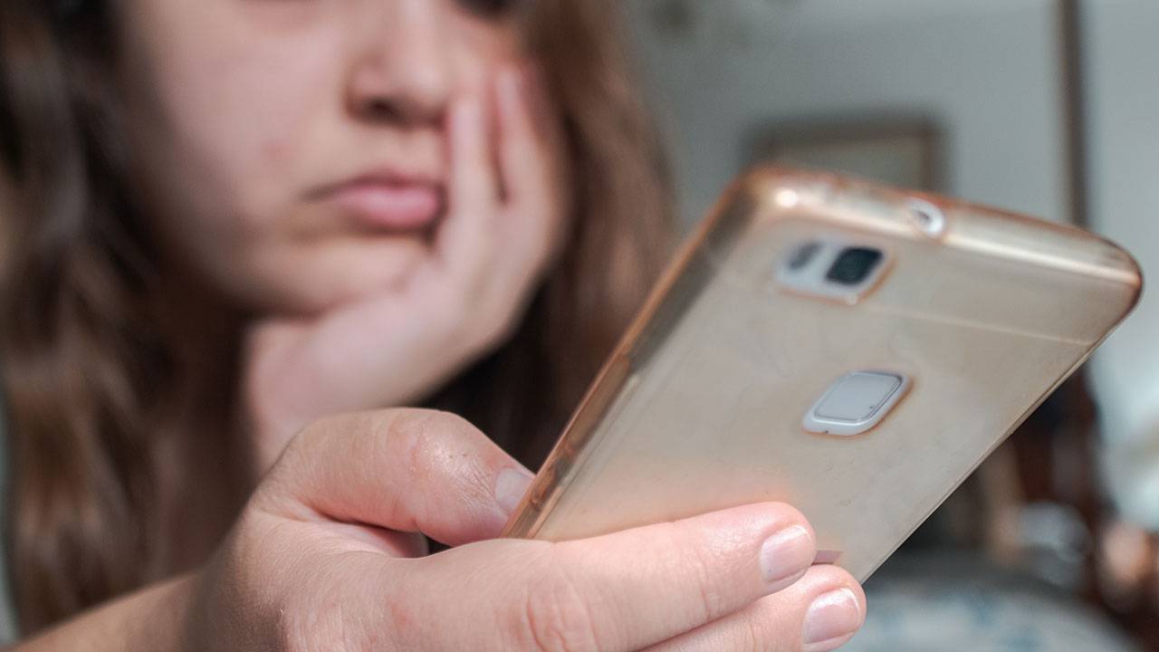 Bored girl looking at phone