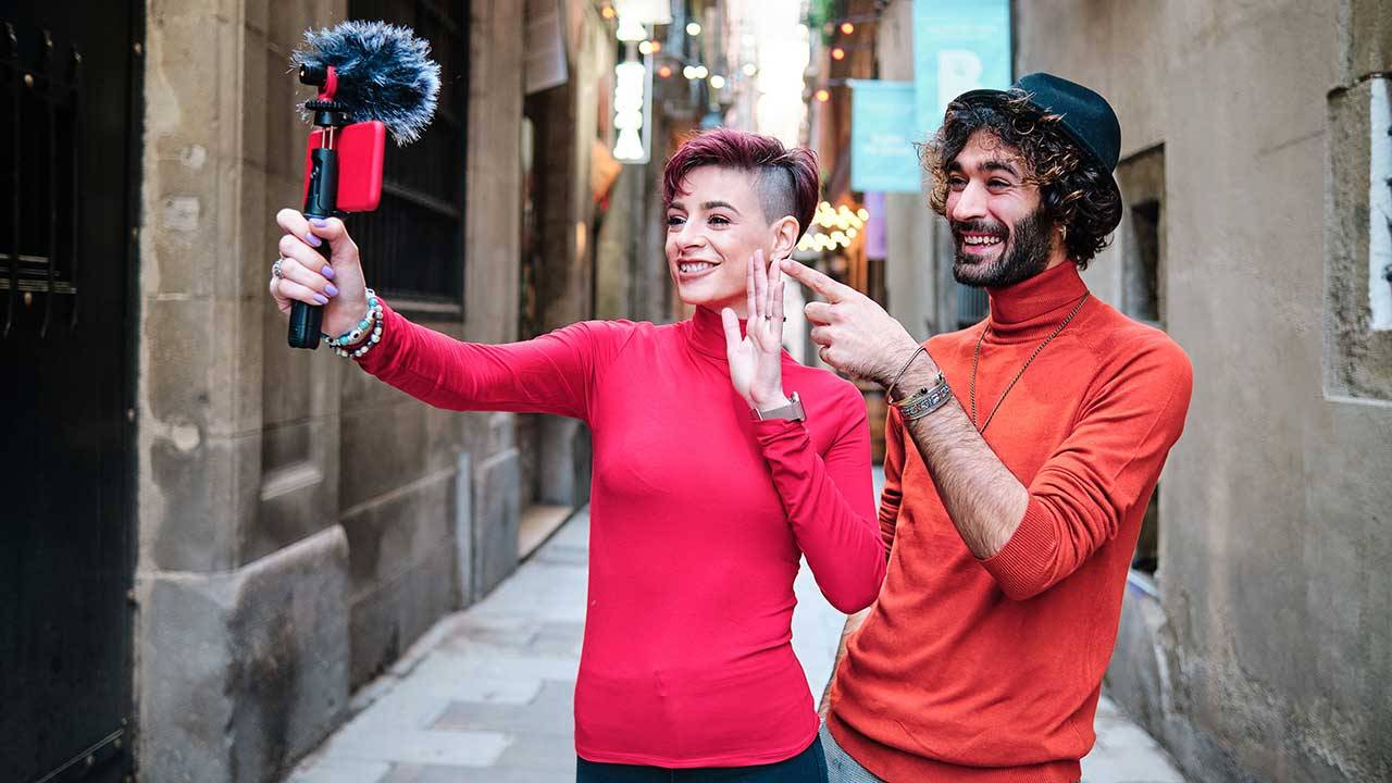 Two creators smiling while filming a vlog together