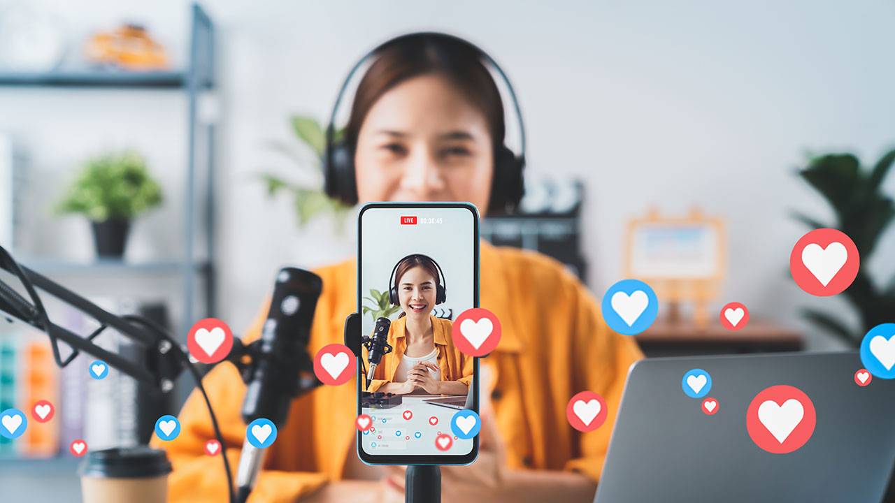 Woman doing a livestream with heart icons surrounding her