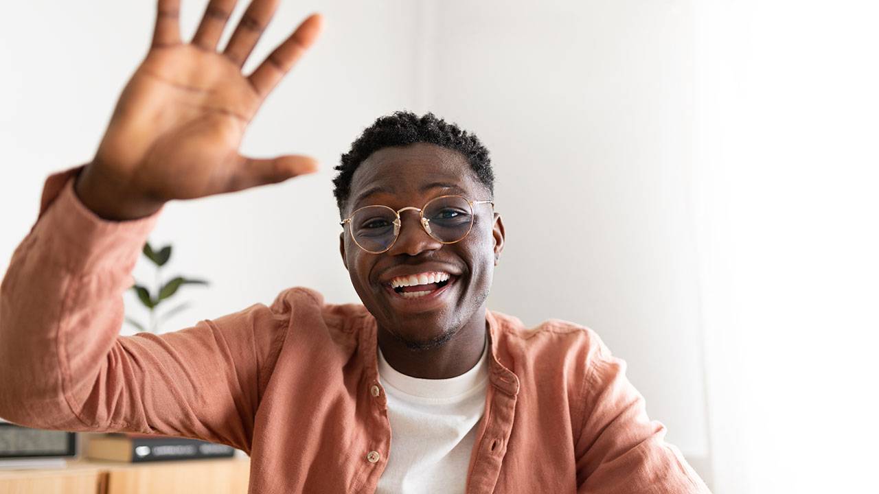 A man waving to the camera