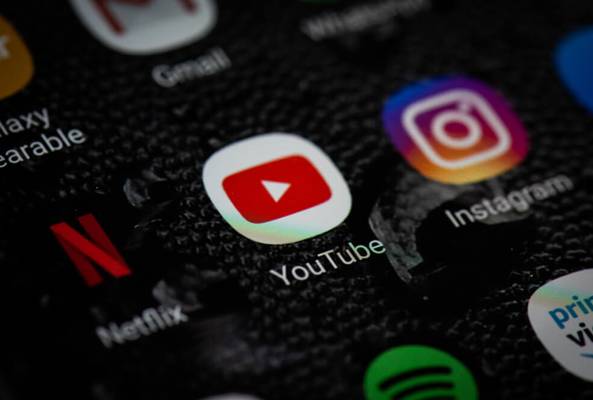 Close-up of YouTube, Instagram, Netflix, and other social media app icons on phone screen