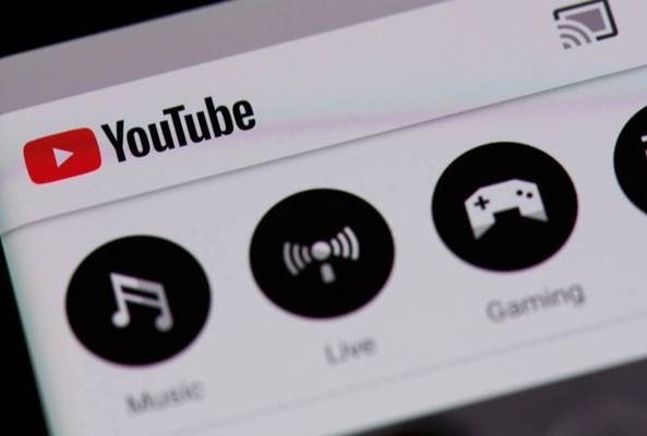 YouTube app interface showing categories for Music, Live, and Gaming features on screen