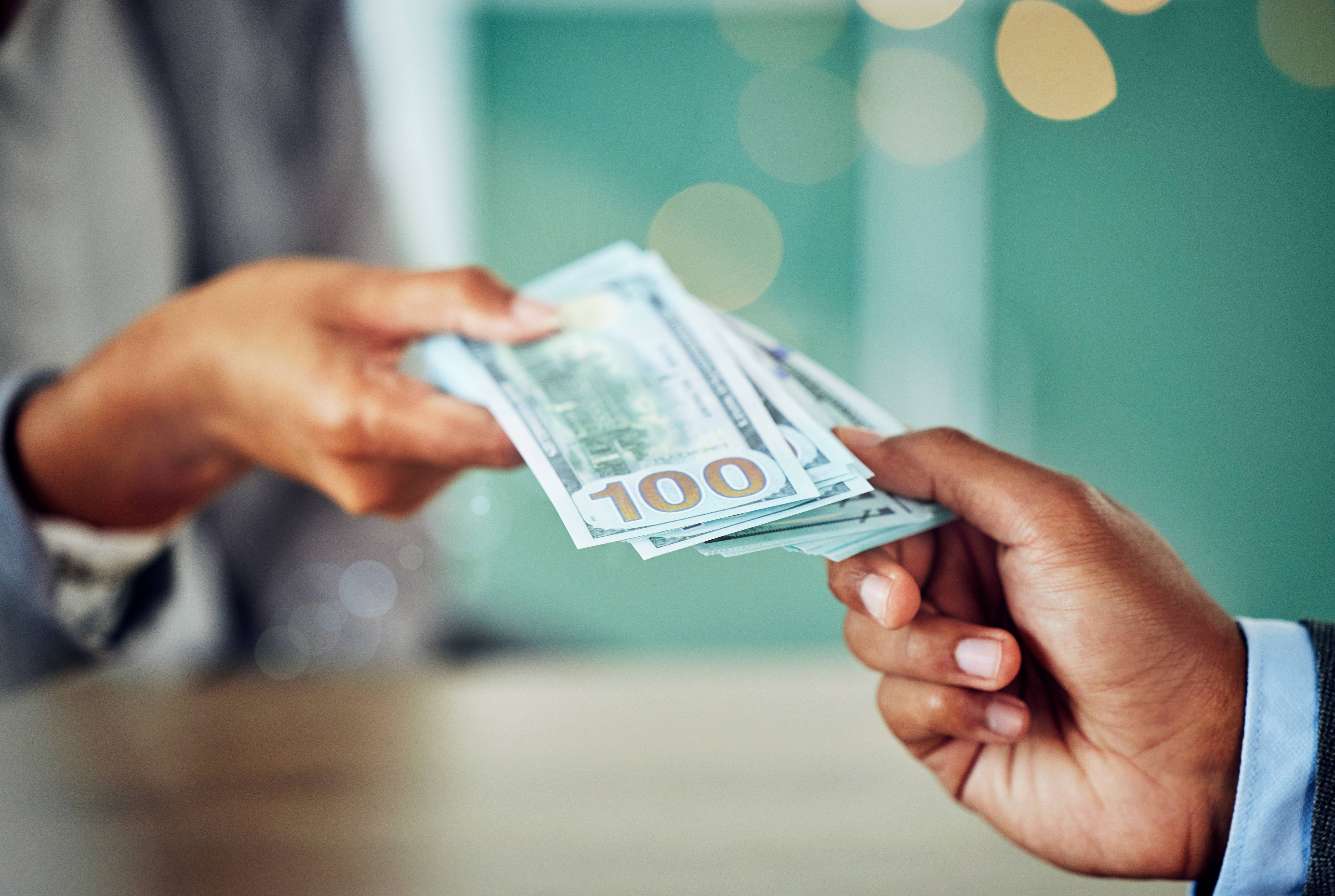 hands exchanging money