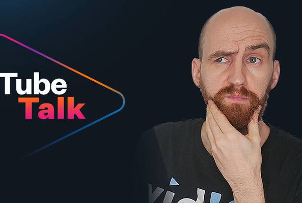 Man with beard thinking beside colorful Tube Talk logo on dark background for video podcast