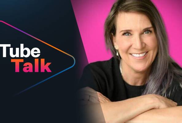 Smiling woman with long hair promoting Tube Talk podcast with dark and pink background.