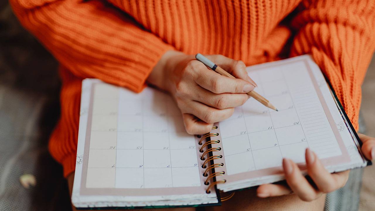 Woman planning youtube videos on her calendar