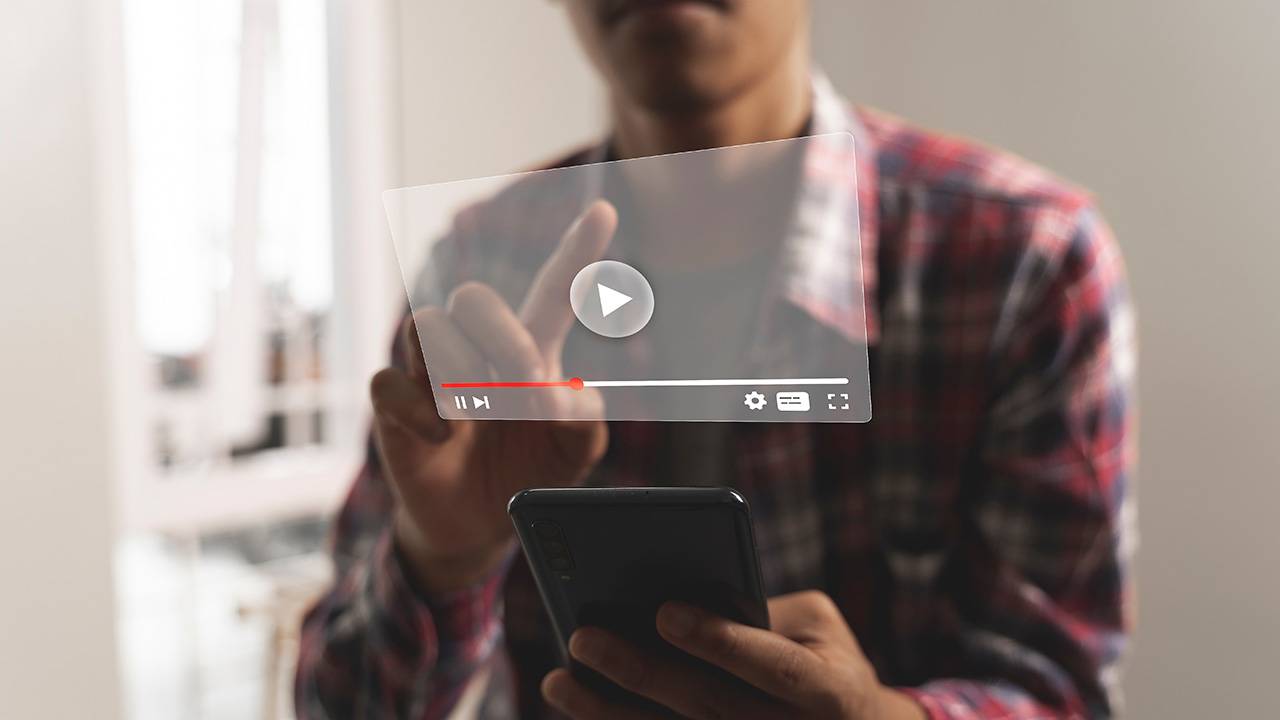YouTube video player graphic that a man is tapping