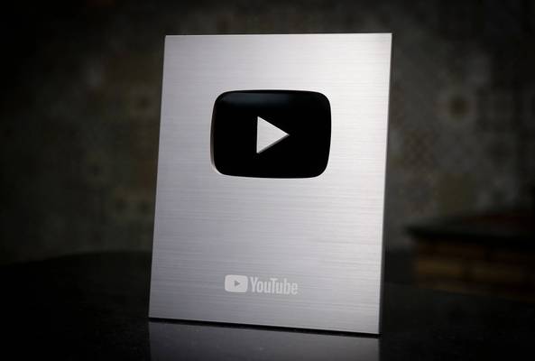 Silver YouTube play button award for reaching 100,000 subscribers
