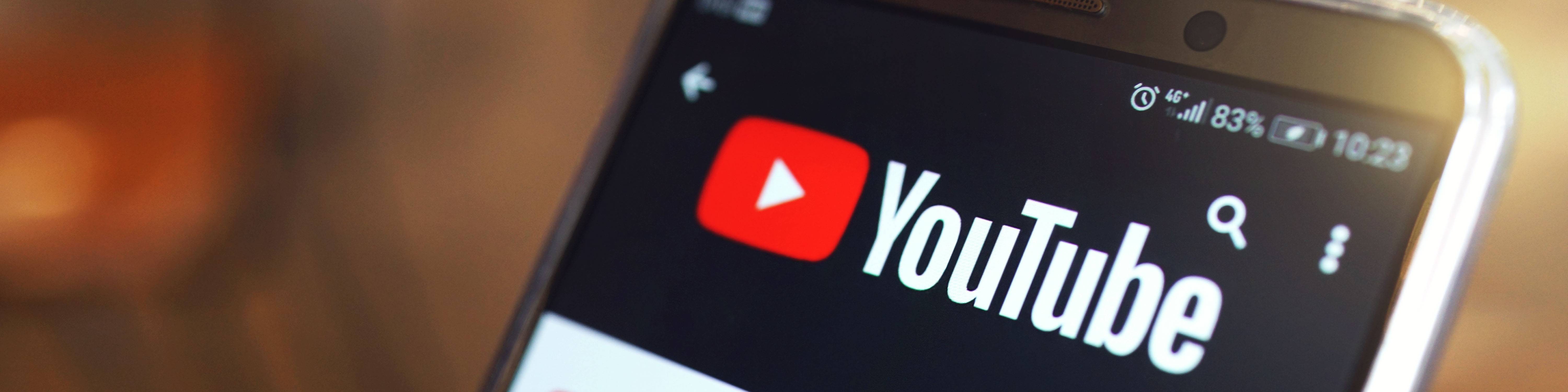 YouTube app open on smartphone screen showing logo and search icon at top