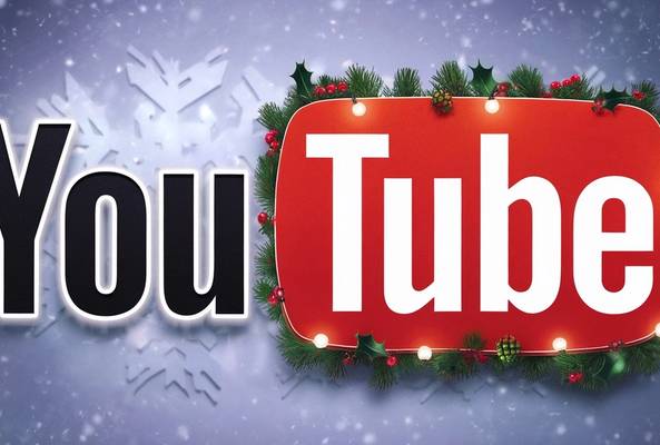 YouTube logo decorated with holiday lights, pine, and holly on snowy background.