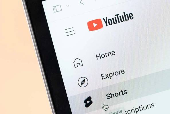 YouTube mobile app menu showing Home, Explore, and Shorts tabs on a smartphone screen
