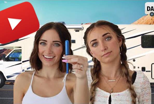 Two women with an RV and YouTube logo, one holding a pregnancy test, Day 1 text