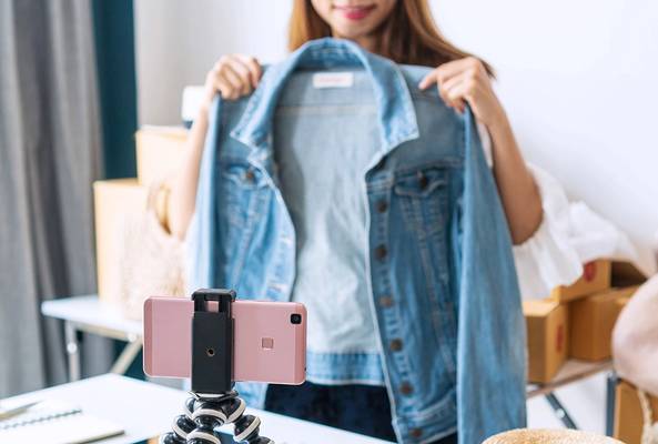 Woman shows camera a denim jacket