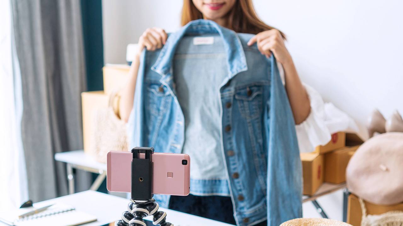 Woman shows camera a denim jacket