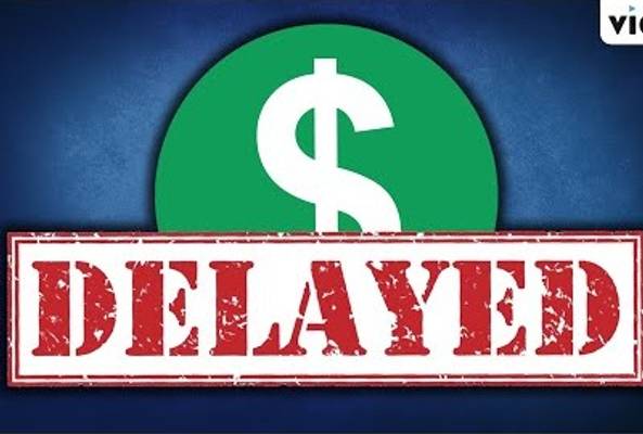 Green dollar sign symbol with red stamped text "DELAYED" on blue background.
