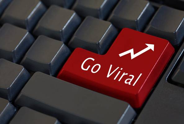 Red keyboard key with "Go Viral" text and upward arrow symbol on black keys background.