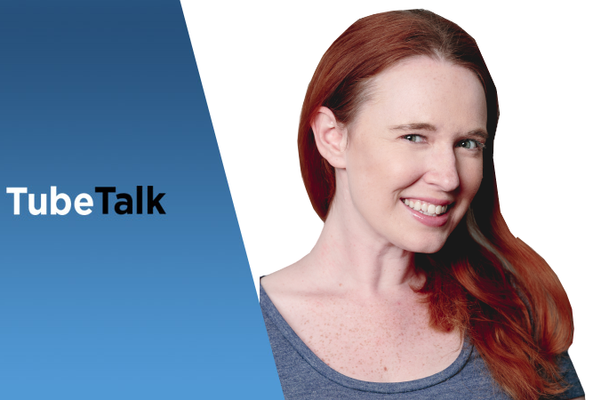 Smiling woman with red hair next to TubeTalk logo on a blue and white background