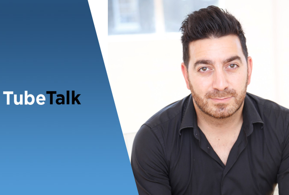 Man in black shirt next to blue background with TubeTalk logo, video content branding.