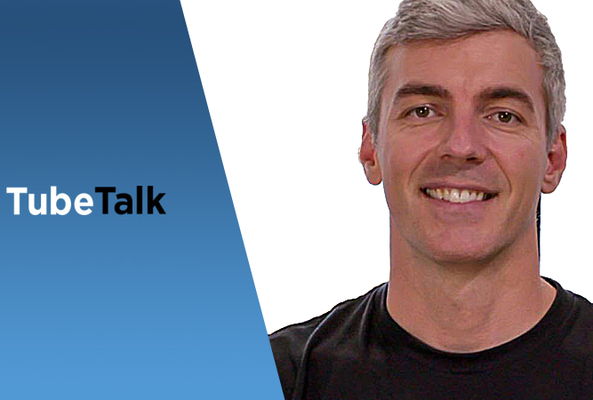 Smiling man with gray hair next to blue TubeTalk logo on white background