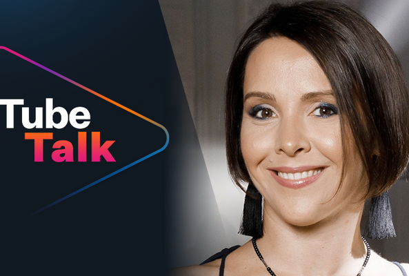 Smiling woman with short hair alongside colorful Tube Talk logo on dark background