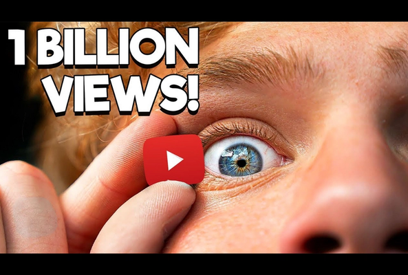 Close-up of eye holding YouTube play button with text "1 billion views" celebration.