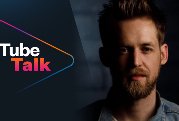 Man with beard next to Tube Talk logo, representing podcast or video talk show branding.